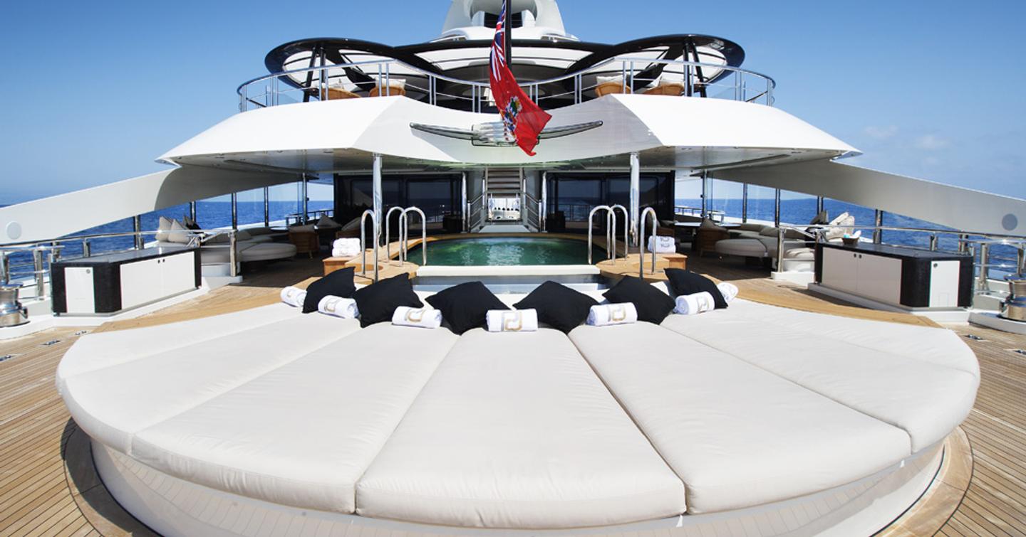 Sunpads onboard superyacht AV. Access to upper salon in background, surrounded by sea.