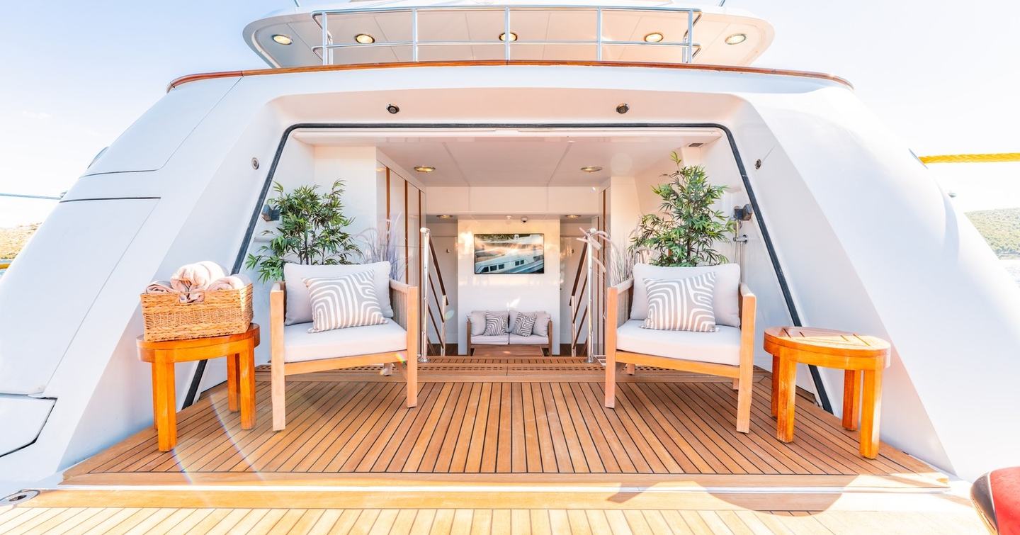 Superyacht Victory's beach club with deck chairs and plants