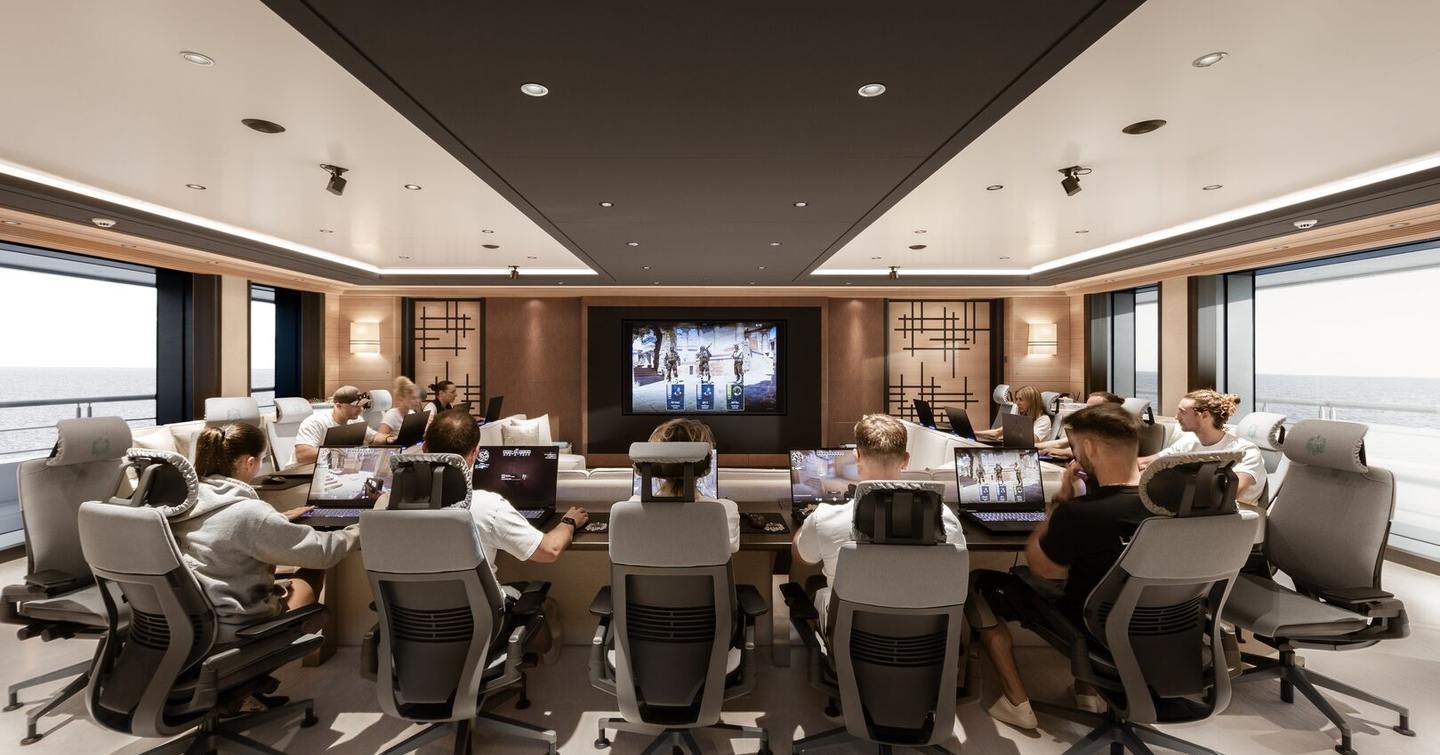 Gamers around table in gaming room on board Oceanco superyacht Leviathan 