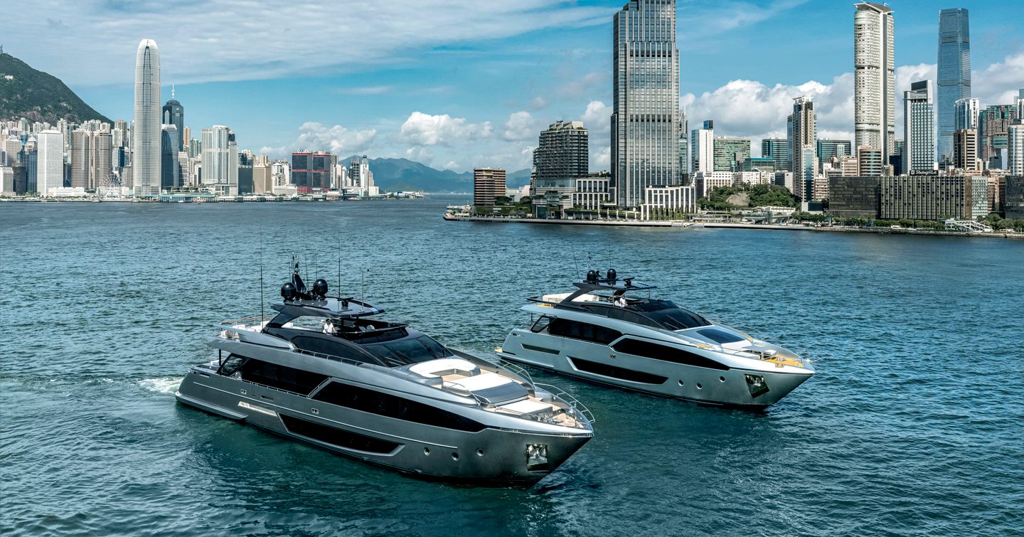 Riva yachts underway, surrounded by sea with cosmopolitan skyscrapers in background