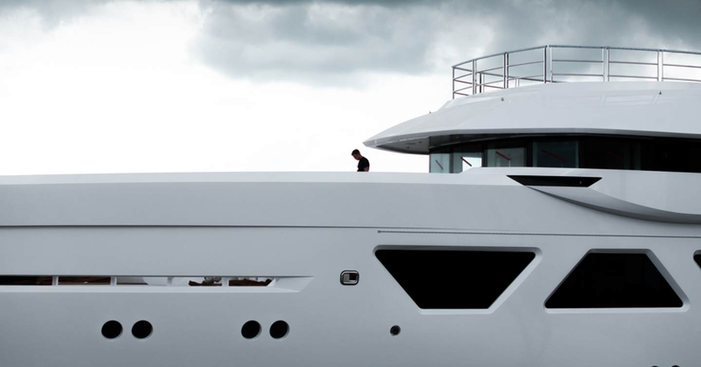 Close up of Eighth Amels 60 motor yacht's superstructure with man on deck 
