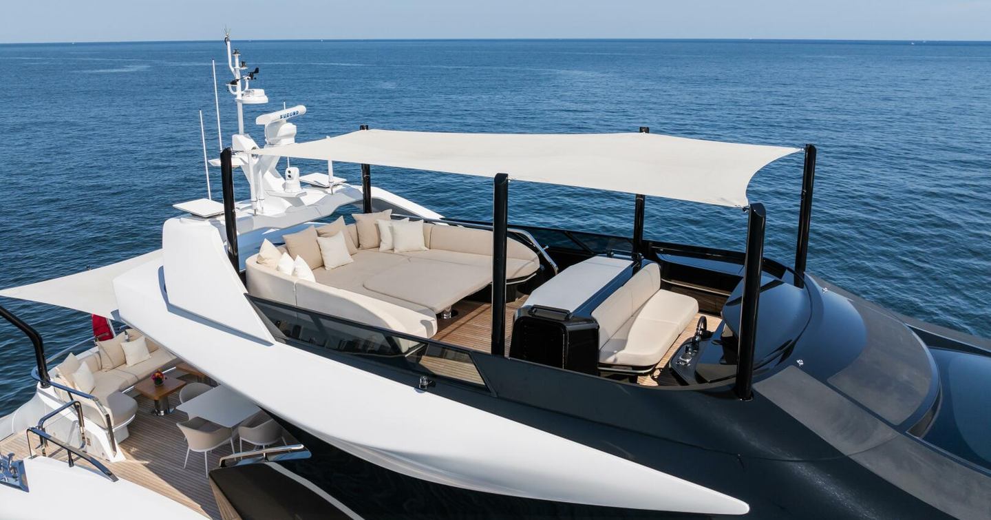 Motor Yacht Jacqpot sundeck with shaded sunpads and helm station