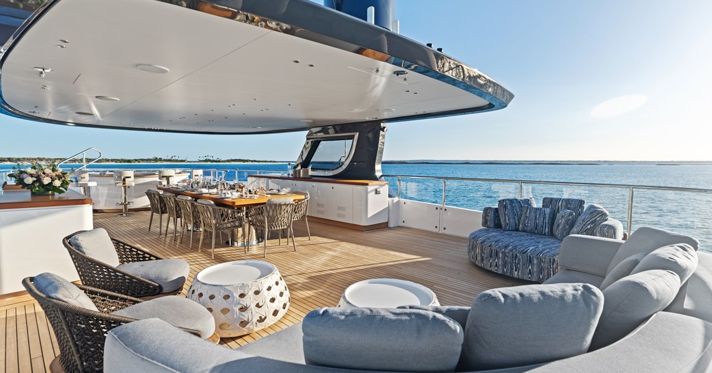 Superyacht Contigo sundeck with curved seating and alfresco dining