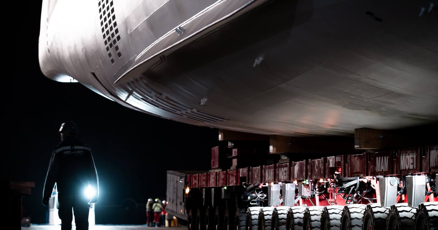 Close up of Oceanco Y729 superyacht hull under construction with worker looking 