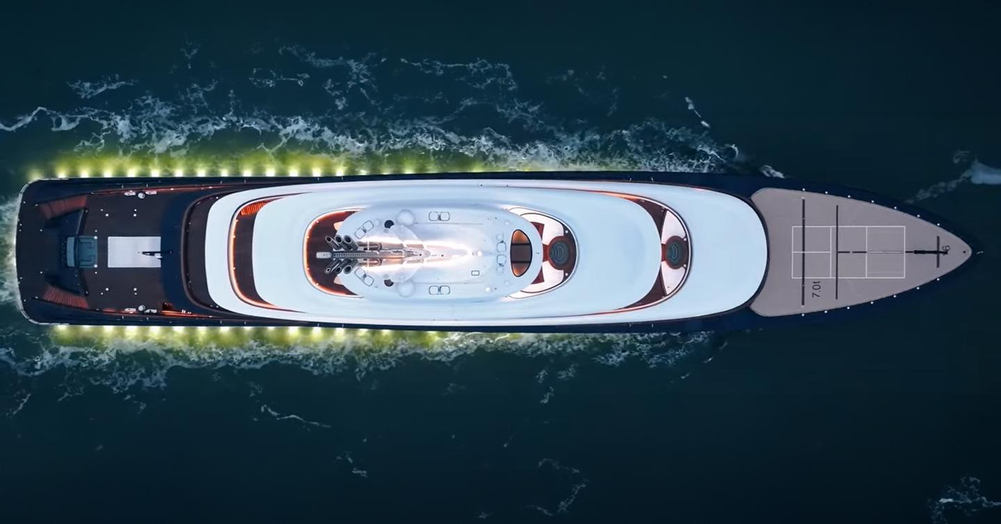 Aerial view of Superyacht Breakthrough under way with underwater lights 