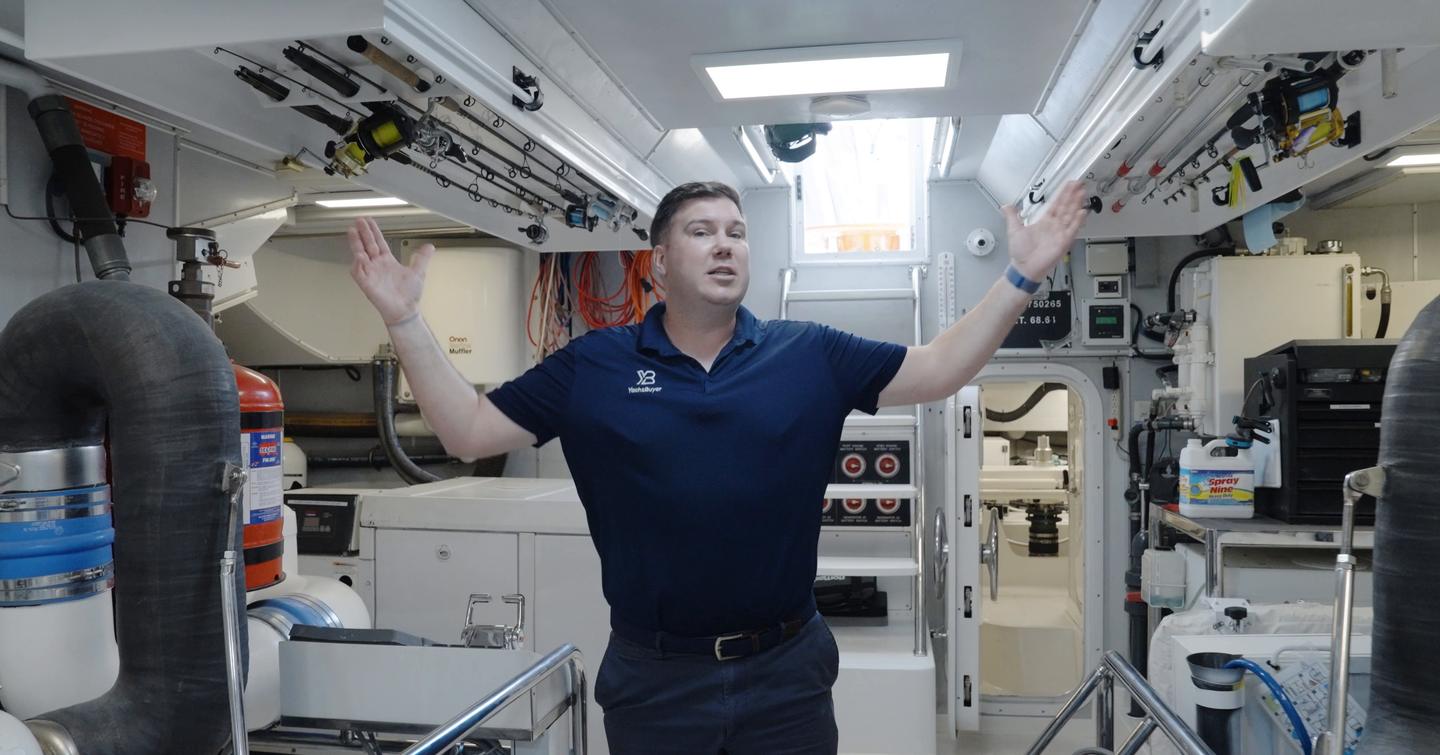 Jack Haines inside the Nordhavn 75 EYF engine room demonstrating full standing headroom and service access