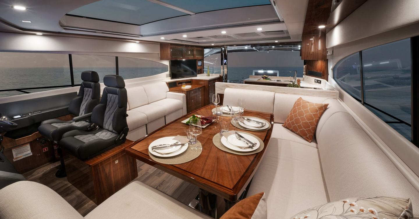 There is a fixed table further forward, opposite the helm 