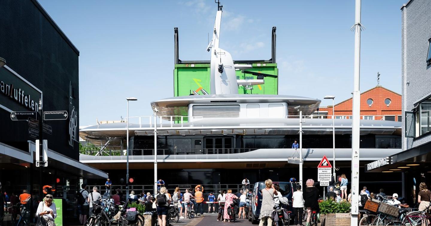 Onlookers watching upper decks of Feadship Superyacht Thalassa (Project 826) travel through Dutch canals 