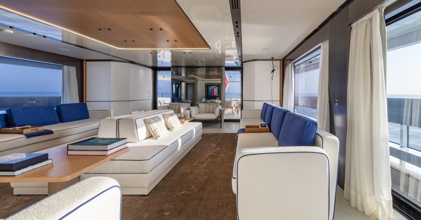 Superyacht Acqua Chiara main saloon with cream furniture and blue accents