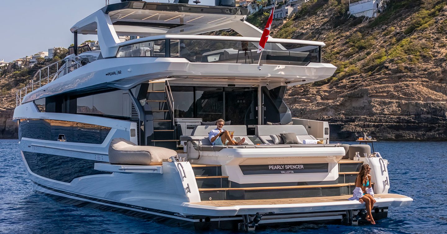 Pearl 82 aft deck shot from water level with guests enjoying the boat