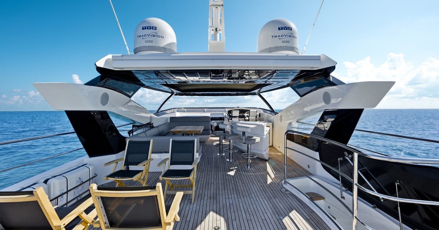 Pura Vida motor yacht flybridge with shaded U-shaped seating and bar area 