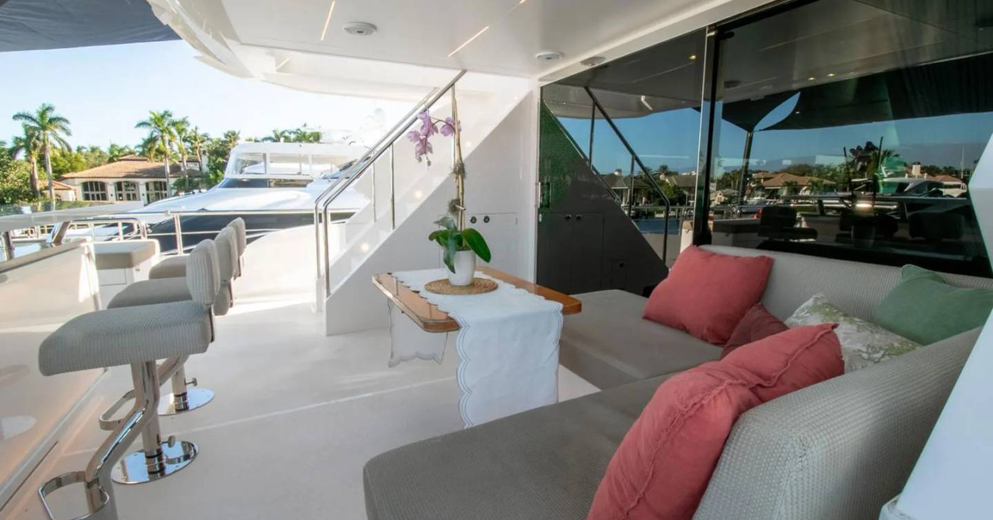 Motor Yacht One More Time aft deck shaded seating and bar area