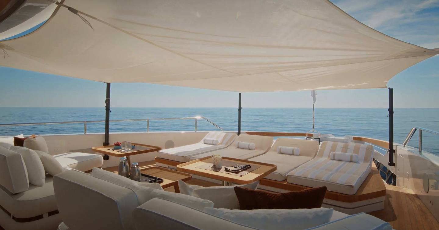 Custom Line Navetta 38 foredeck with sunpads, seating area and adjustable layout under sunshade canopy