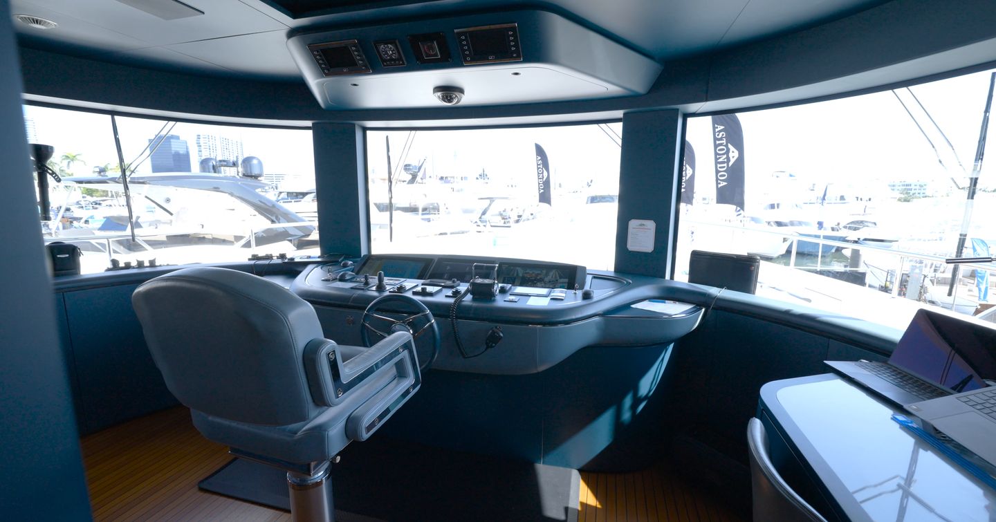 Benetti Oasis 34M wheelhouse with central helm station, panoramic windscreen and captain's navigation workspace.