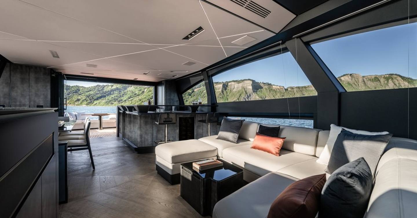 Interior of Pershing GTX80 motor yacht saloon with U-shaped sofa
