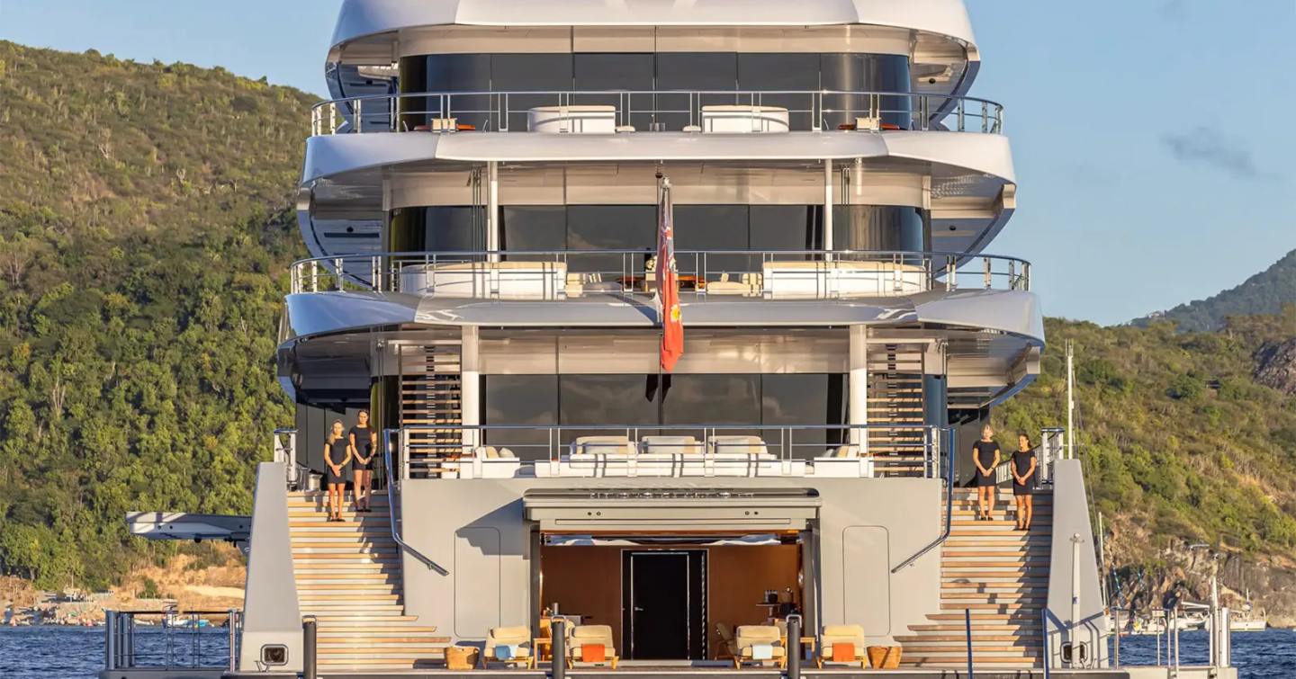 Workers standing on staircase of Superyacht Moonrise while docked 