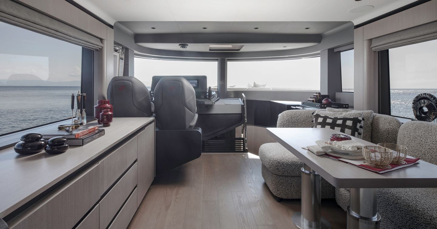 Sirena 60 motor yacht main saloon with grey U-shaped seating and helm station
