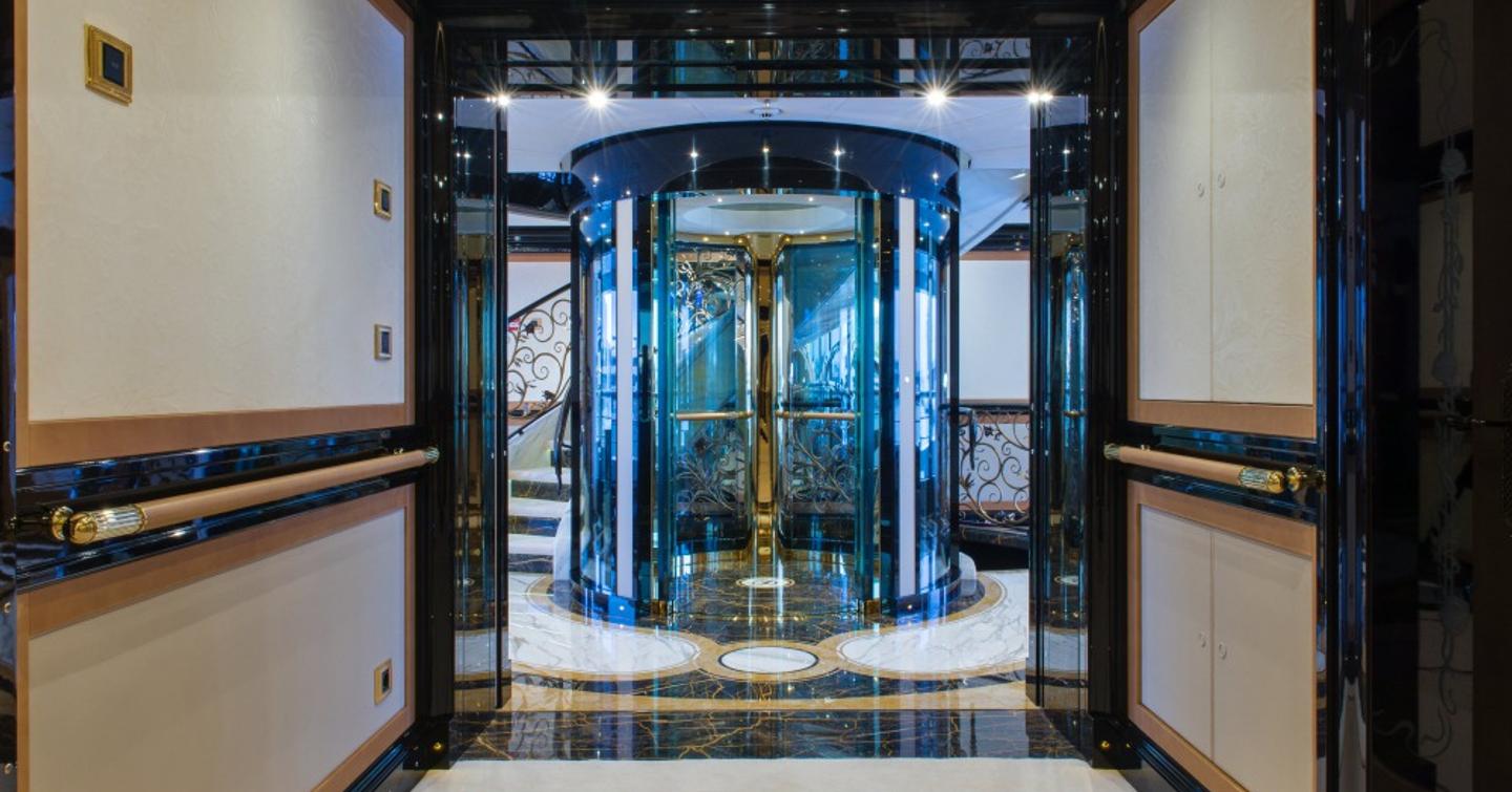 Superyacht I Dynasty interior spiral staircase with glass covered lift