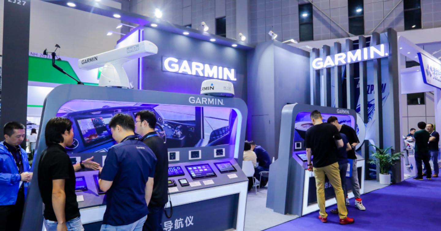 Overview of Garmin exhibitor at China International Boat Show, colleagues and visitors in discussion at forefront