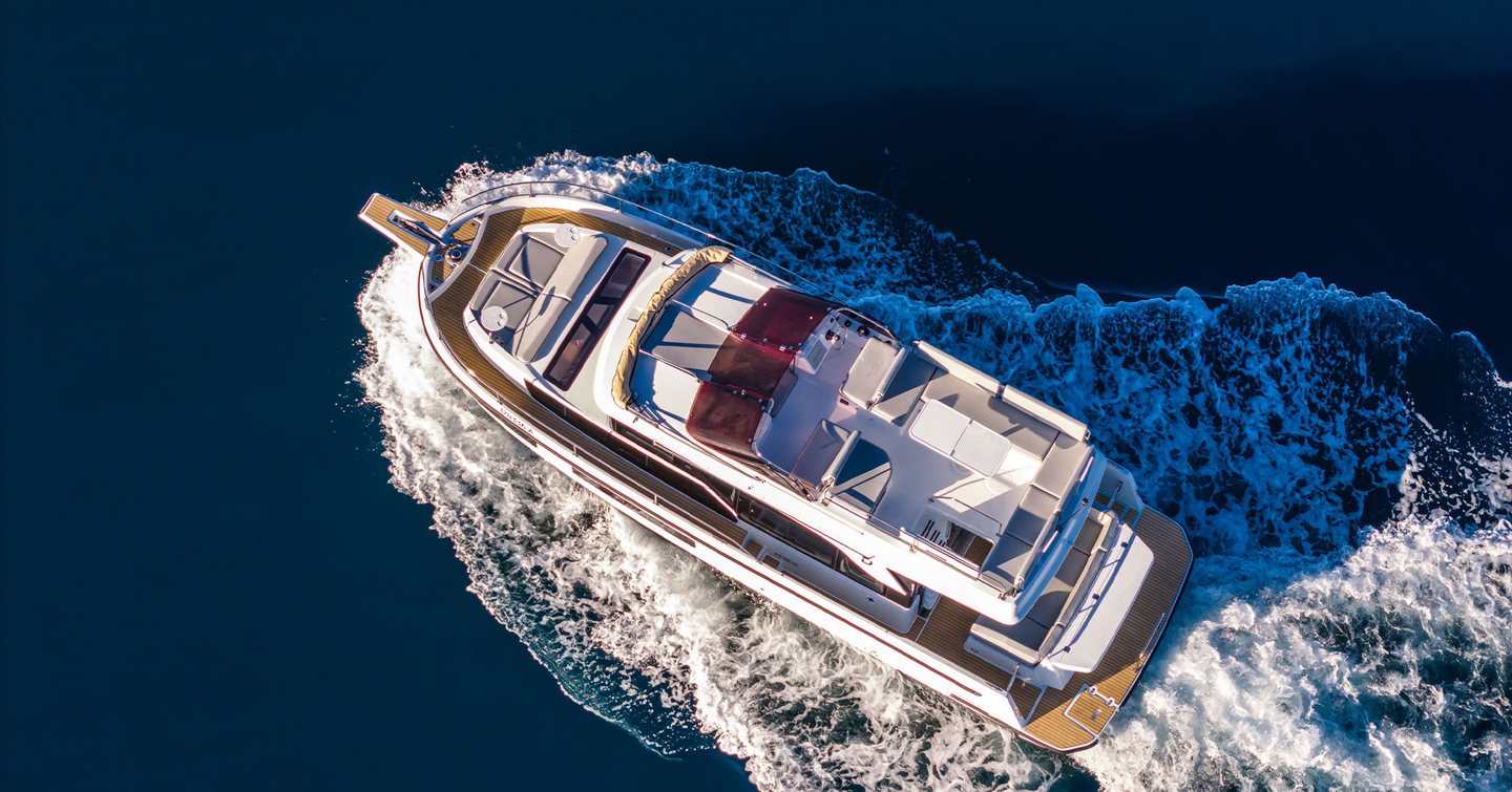 Aerial view of Updated Delphia 11 Flylounge Motor Yacht under way 
