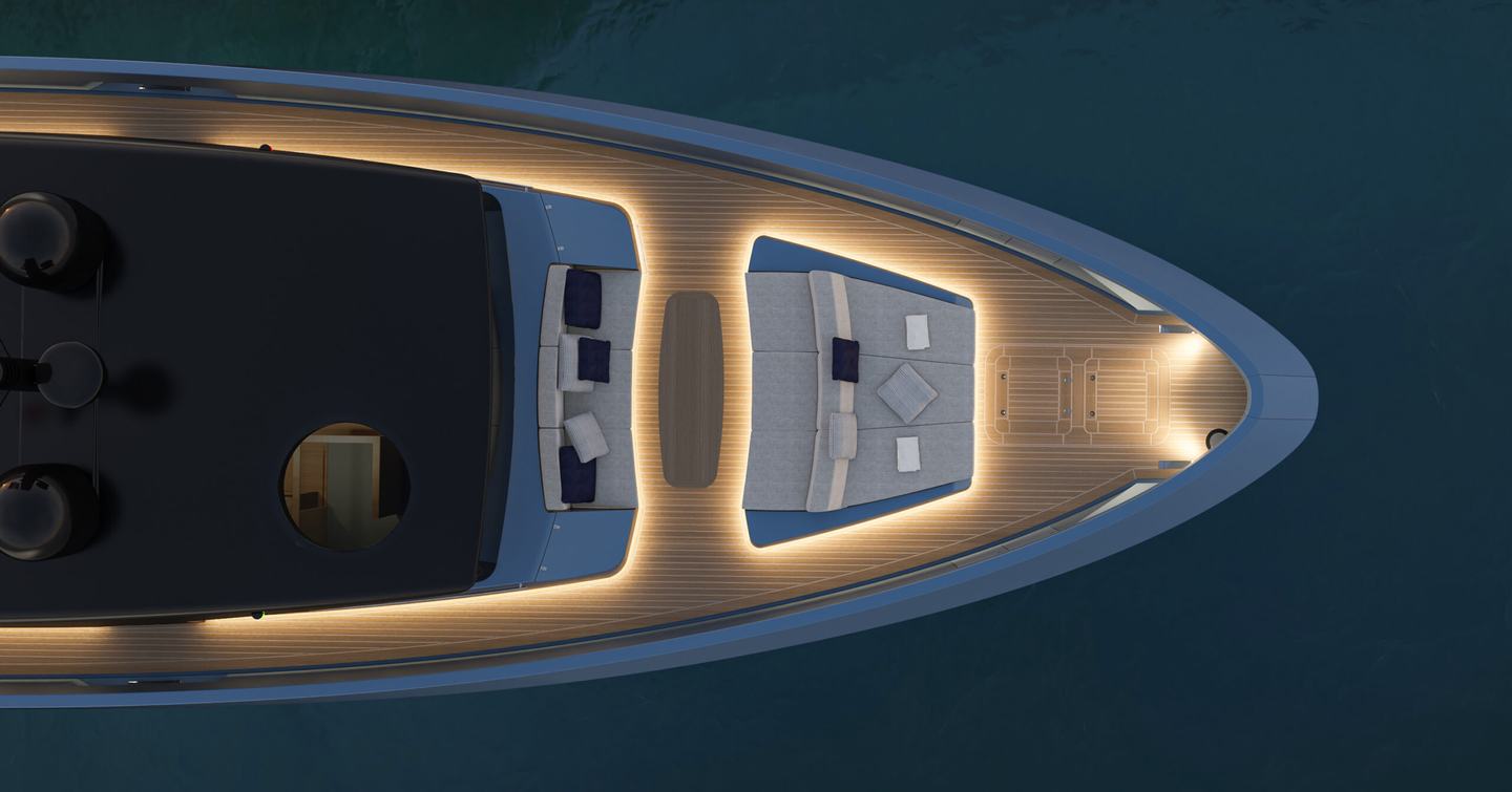 Overhead view of the Manda S07 Berlinetta foredeck showing sunpads and forward dining area with integrated deck lighting at anchor