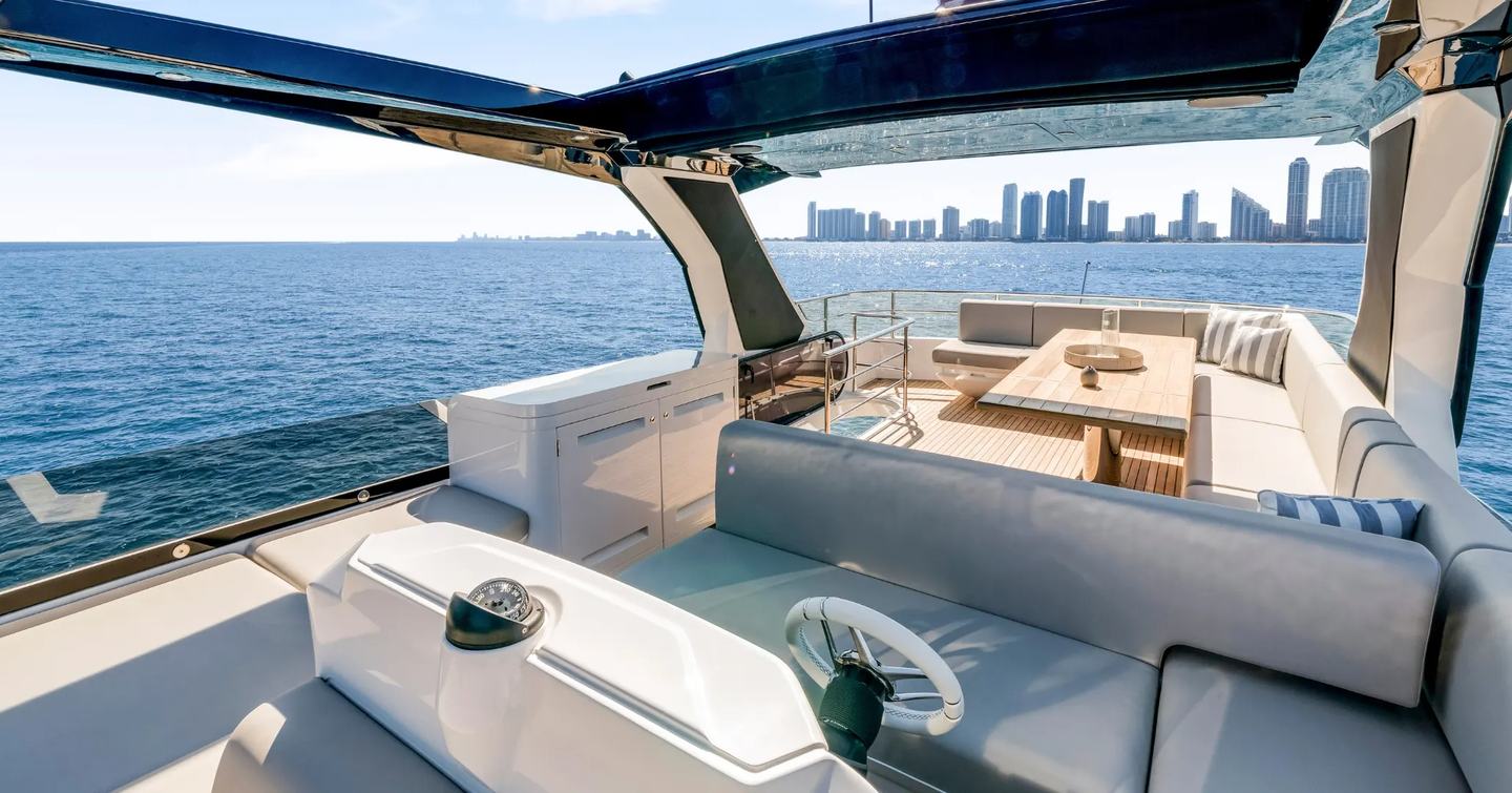 Flybridge on motor yacht Manhattan 68 with helm station and lounging area