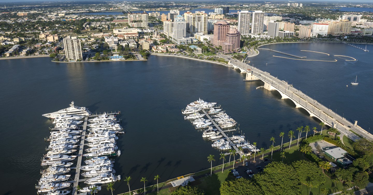 Aerial view of West Palm Beach, multiple motor yachts berthed in marina.