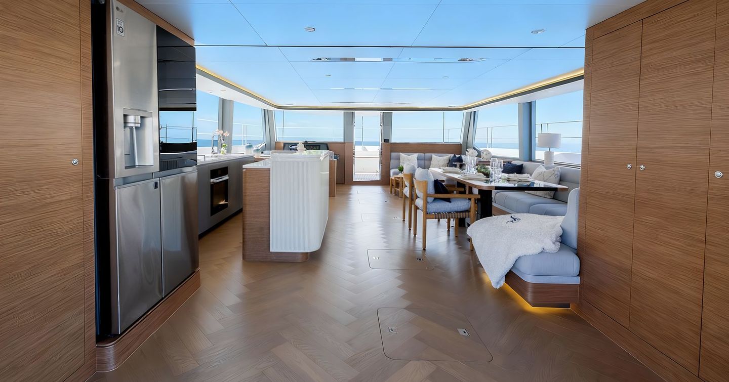 Oceanwalker S60 Catamaran interior with grey furniture and galley 
