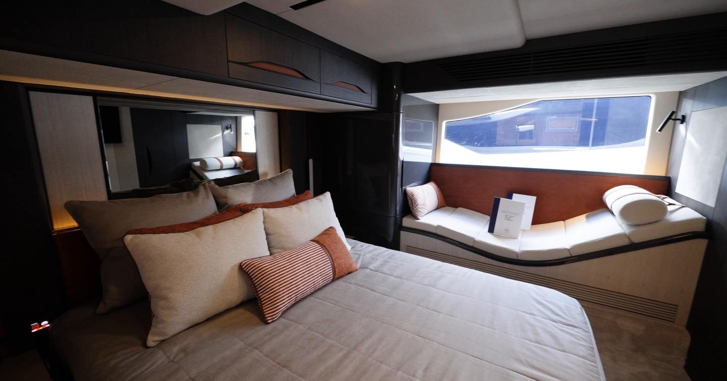 Galeon 520 Fly owner’s cabin with full-beam layout, large hull window and lounge seating area