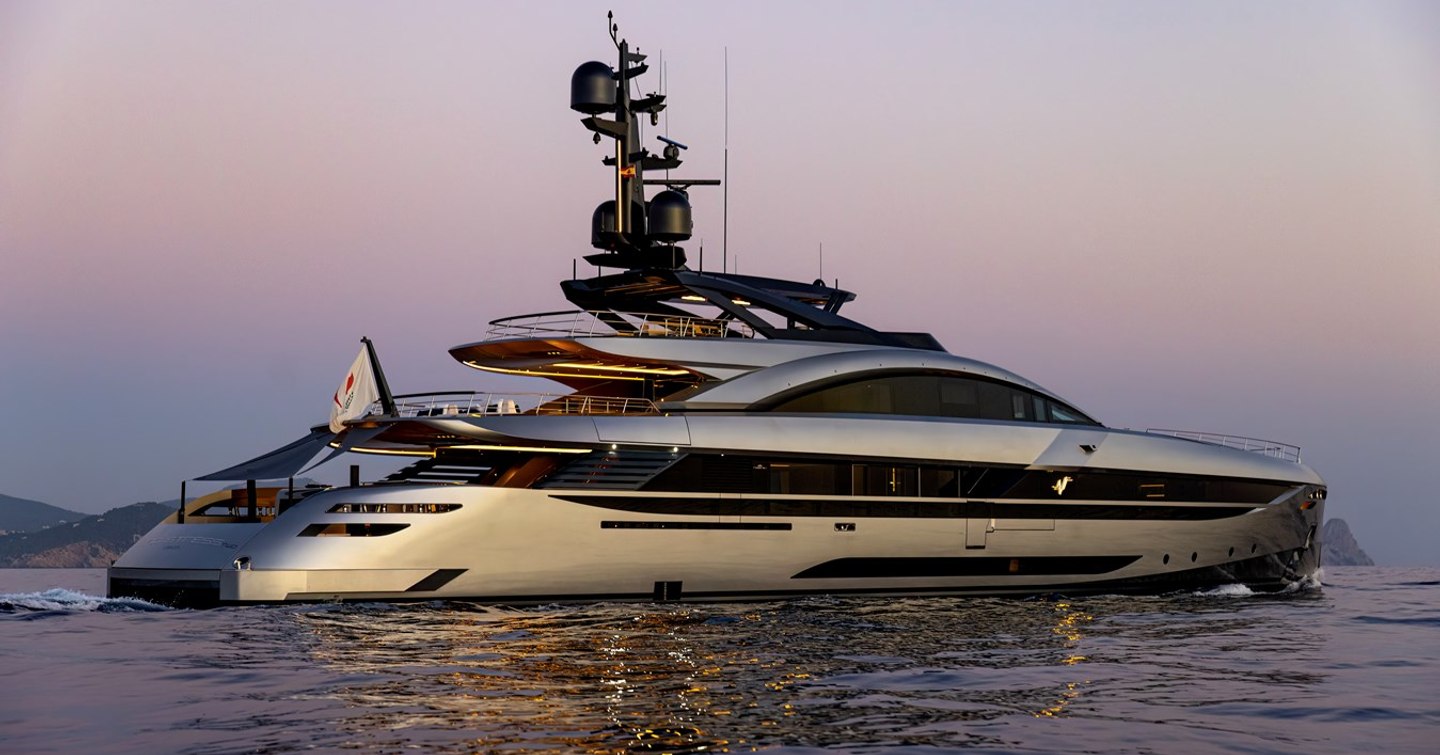 Superyacht No Stress under way at dusk