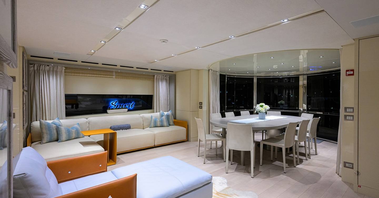 Motor yacht Phoenix's skylounge with circular table and lounge area 