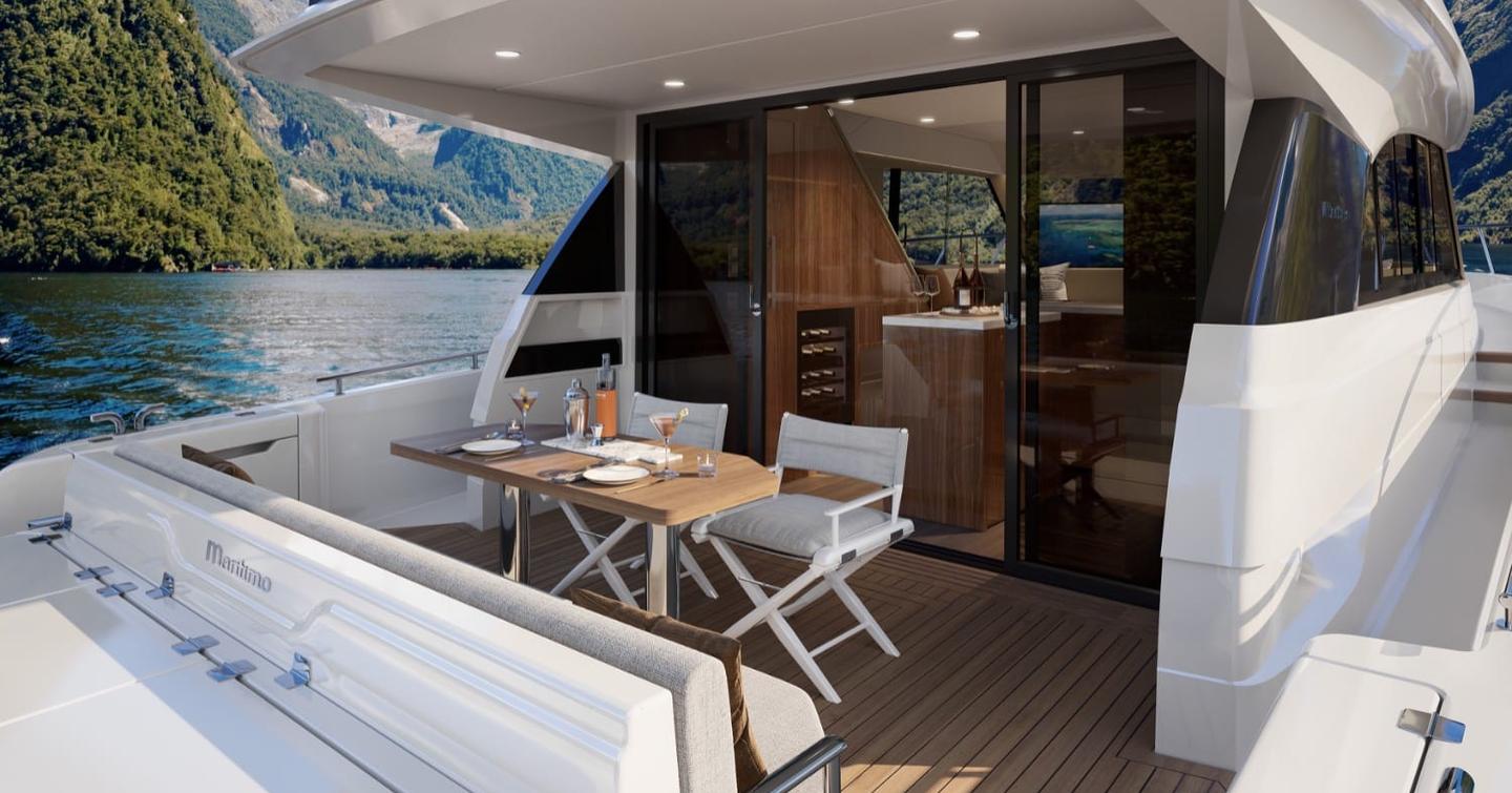 Maritimo M50 aft cockpit dining area with sliding glass doors and teak decking