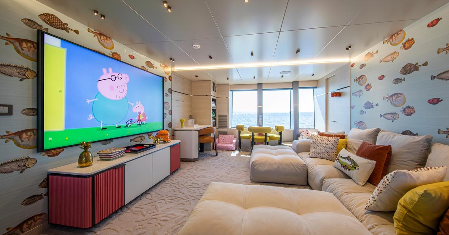 Superyacht Oscar's children's room with mounted TV and desk area 