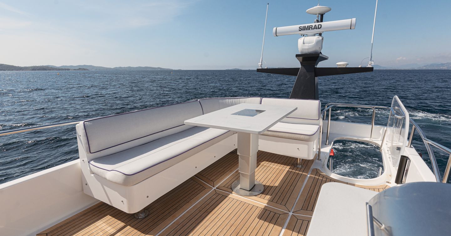 Nord Star 49+ motor yacht flybridge aft with grey L-shaped sofa 