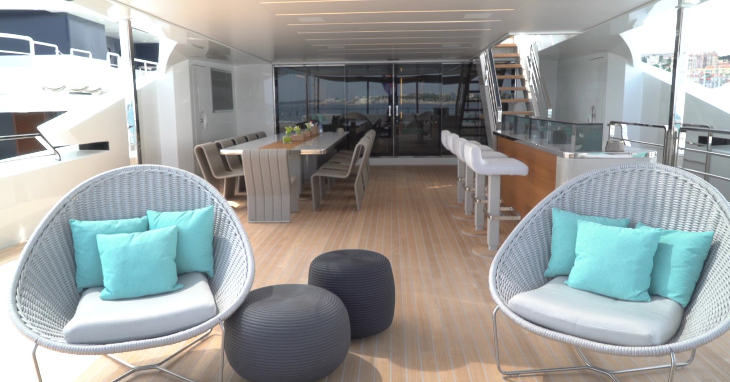 Superyacht Utopia IV bridge aft deck with shaded alfresco dining and wet bar