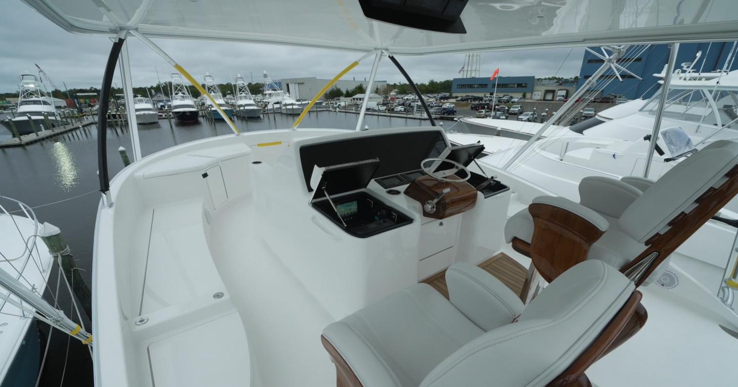 Viking Yachts 74C flybridge helm boasts 6-inch platform and flush screens