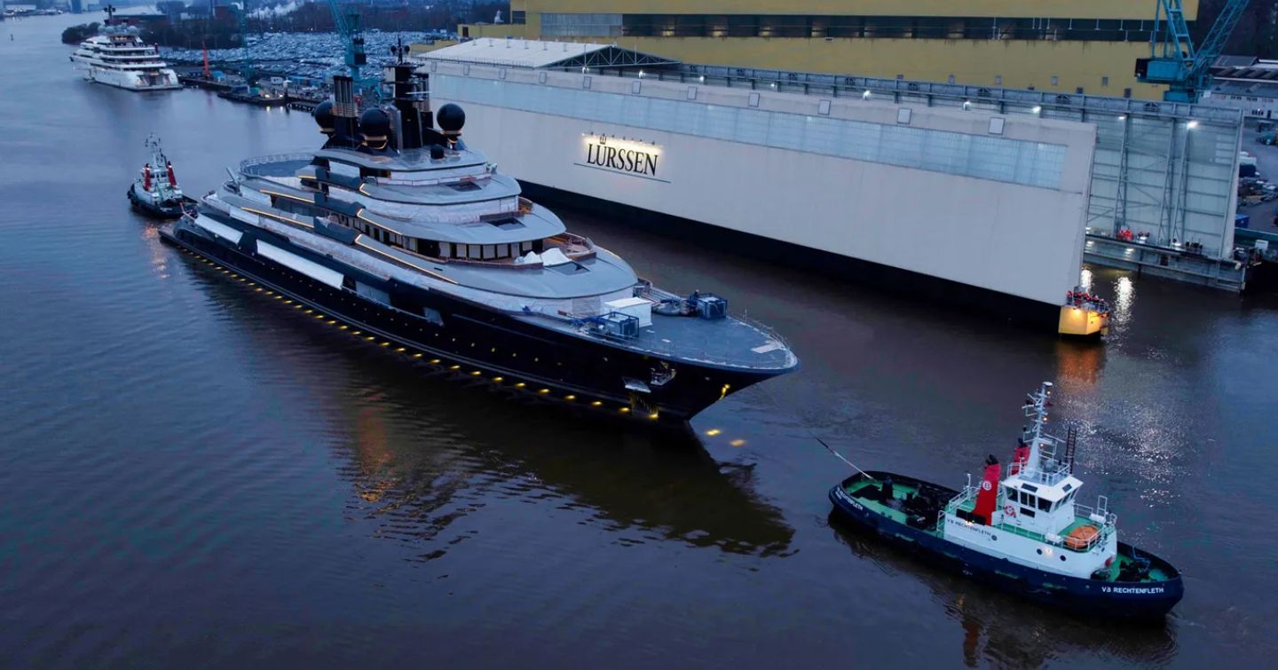 Superyacht LUMINANCE being towed from construction shed in Germany.