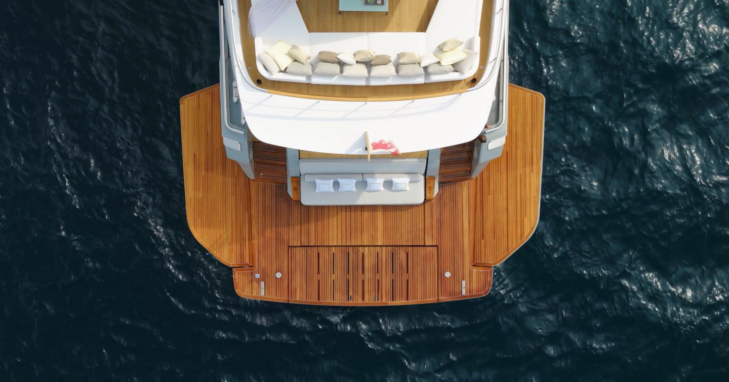 Custom Line Navetta 38 beach club from above with wide swim platform and fold-down terraces at water level