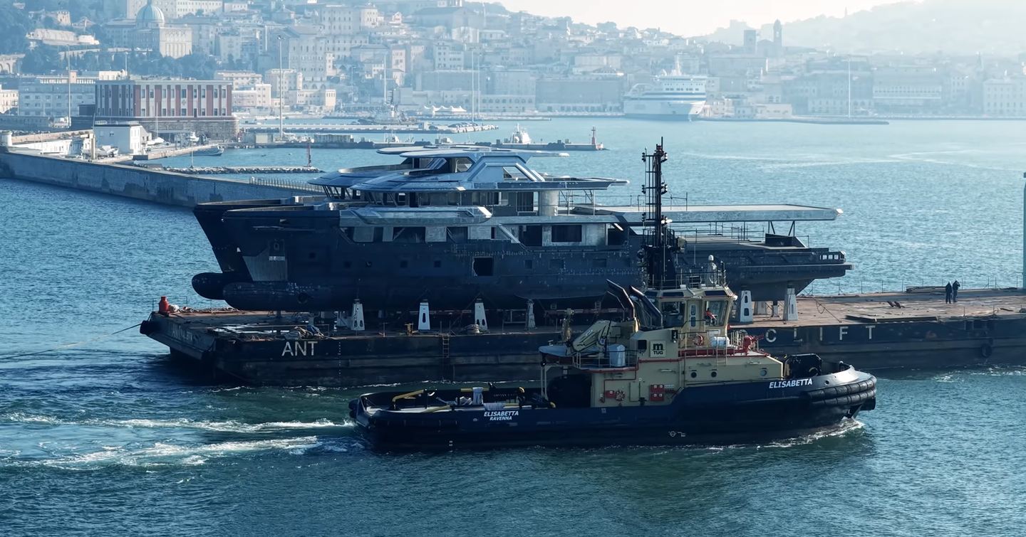 CdM Flexplorer 165 explorer yachts pre-outfitting being transported next to tugboat