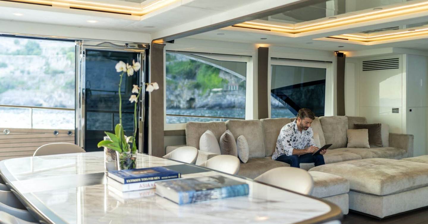 Motor Yacht Vivaldi's interior with man sitting on sofa