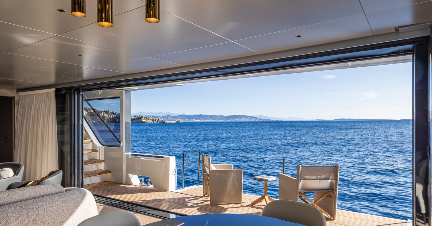 Arcadia A96new Superyacht main saloon with large sliding glass doors and balcony 