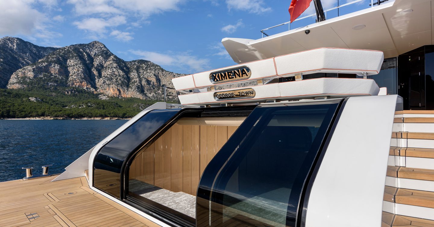 Alia Superyacht Ximena stern with sliding glass doors and dual staircase 