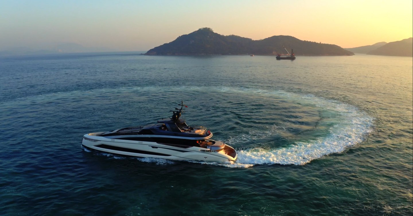 Superyacht Adamas 6 with rugged coast in background