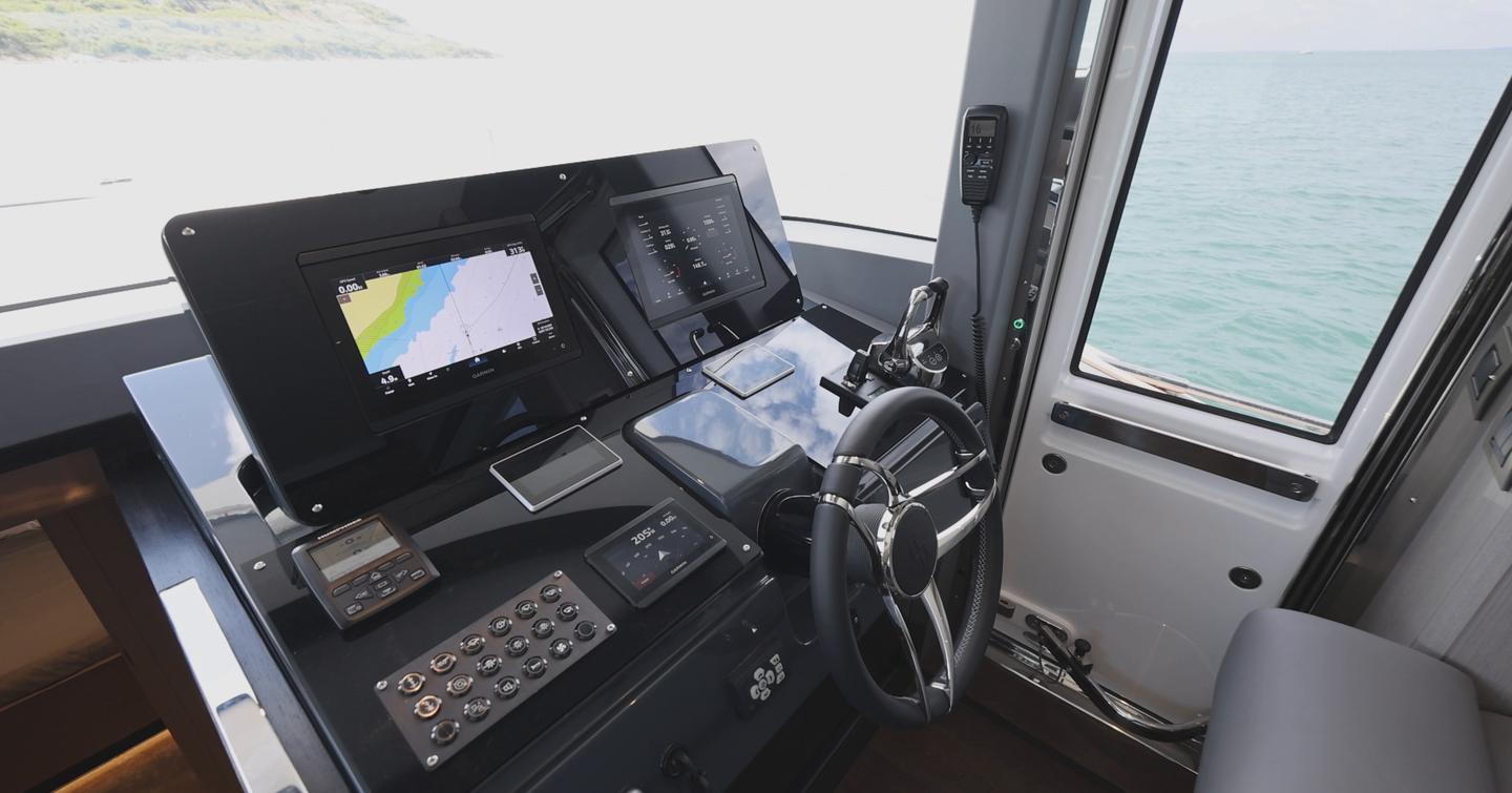 Sirena 48 lower helm with Garmin displays, throttles and side door