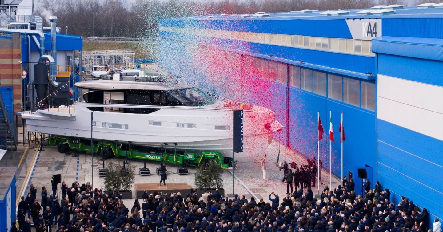 Superyacht Eterna at launch ceremony next to Avigliana shipyard team and red and blue confettie