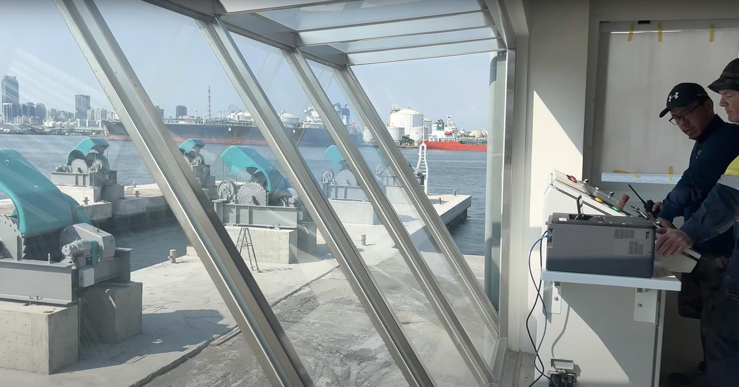 Workers at controlling station behind glass at Horizon yacht shipyard 