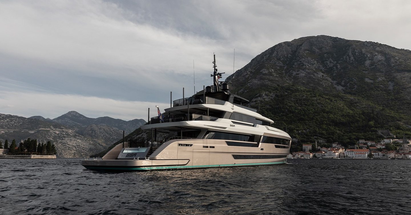 Superyacht Gisa's aft with mountains in the background