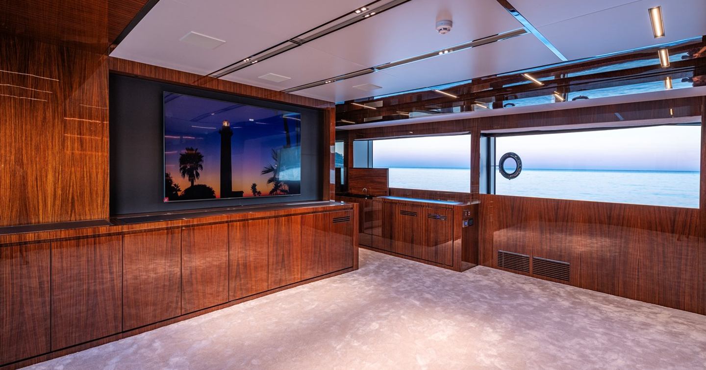 Superyacht Taku interior entertainment space with mounted TV