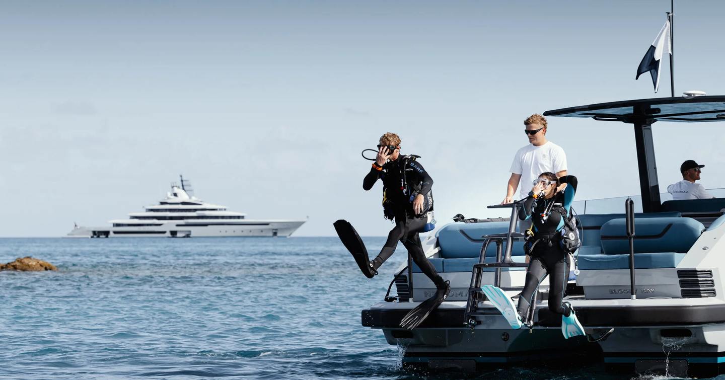 Oceanco superyacht Leviathan guests diving with crew support  