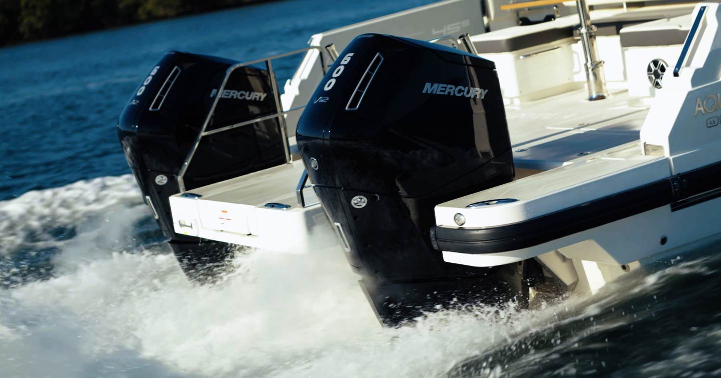 Aquila 45 Sport twin Mercury Verado V12 600hp outboard engines underway, showing wide spacing and central walkthrough to swim platform